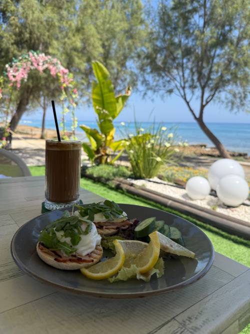 plate of food and a drink outside in the sun and shade